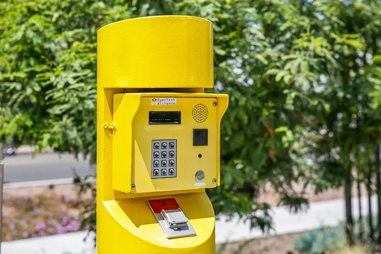 Yellow keypad entry box for a storage facility.