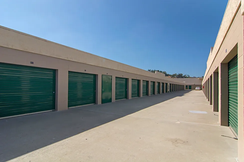 Drive up exterior storage units with green doors.