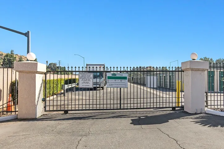 Front gate of a storage facility with a moving truck.