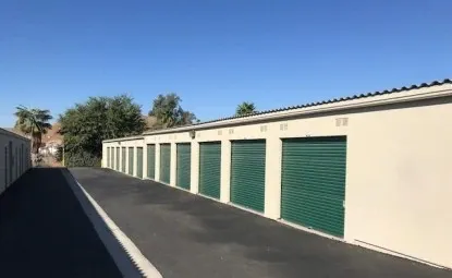 A row of green outdoor storage units.